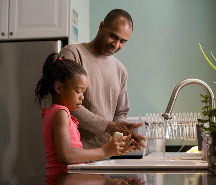 Father and daughter washing hands